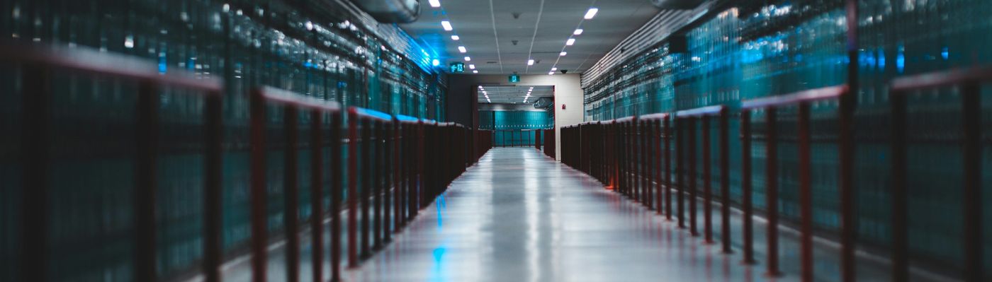 A long data hall aisle between rows of cabinets
