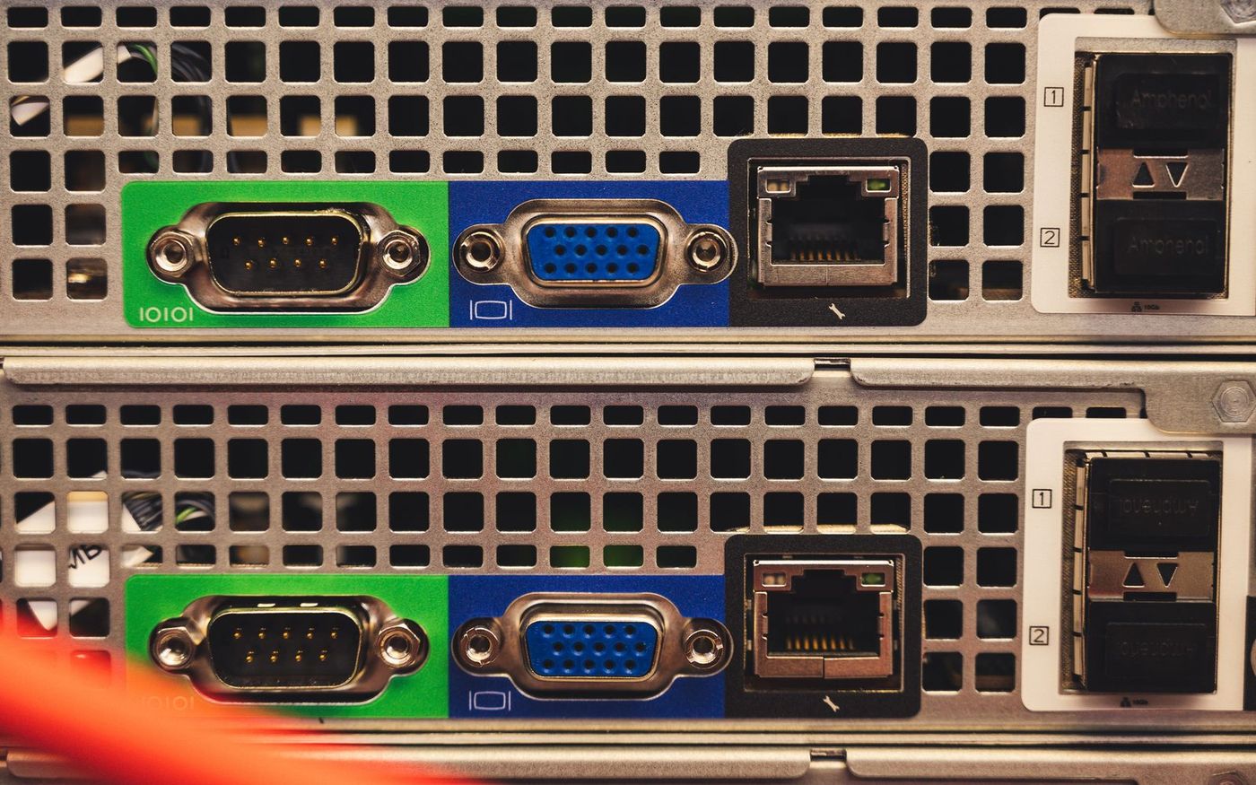 The rear panels of two rack servers, each with an empty network port